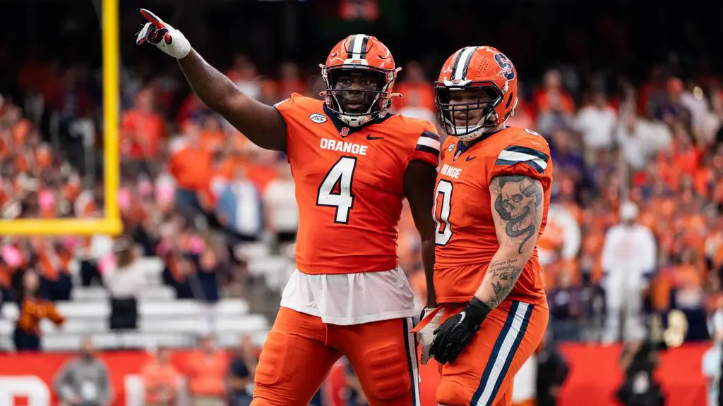 Syracuse football wearing white helmets, orange jerseys, white